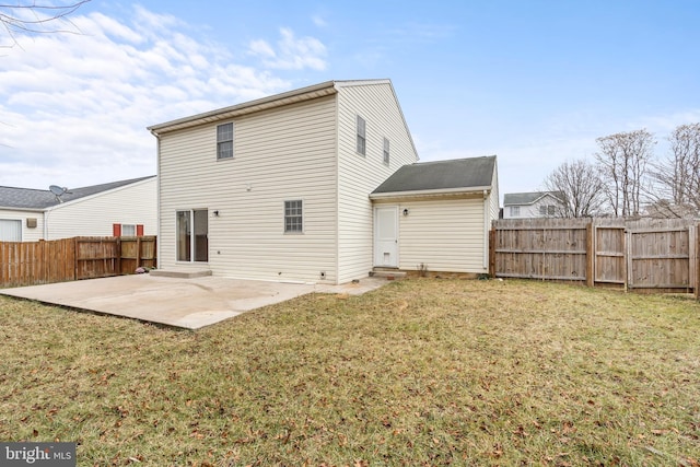 rear view of property featuring a patio and a lawn