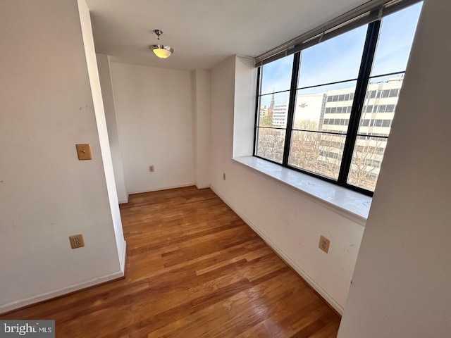 unfurnished room featuring hardwood / wood-style flooring