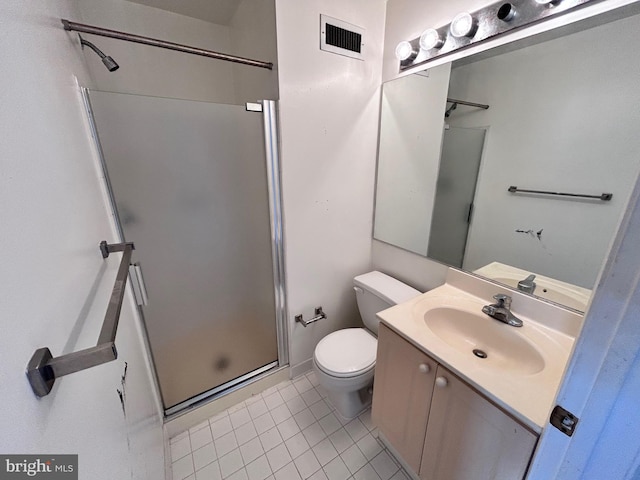 bathroom with vanity, toilet, tile patterned floors, and walk in shower