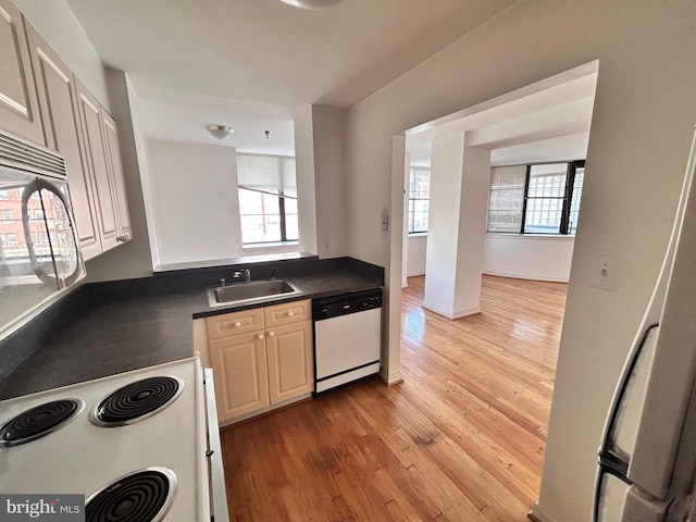 kitchen with white appliances, sink, and light wood-type flooring