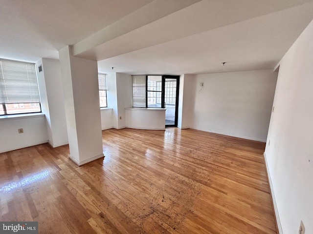 empty room with light hardwood / wood-style flooring