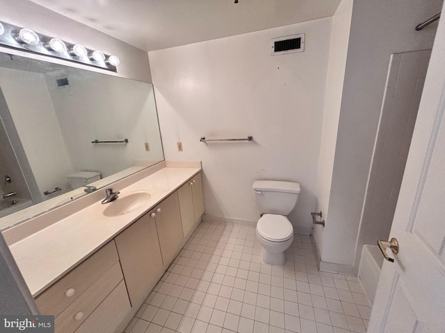 bathroom featuring tile patterned flooring, vanity, and toilet