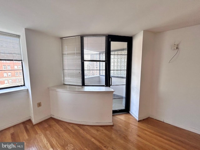 unfurnished room with light hardwood / wood-style floors