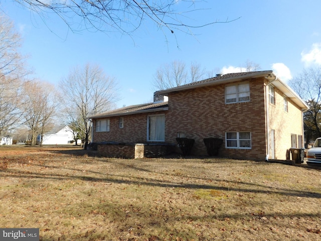 view of side of home with a lawn