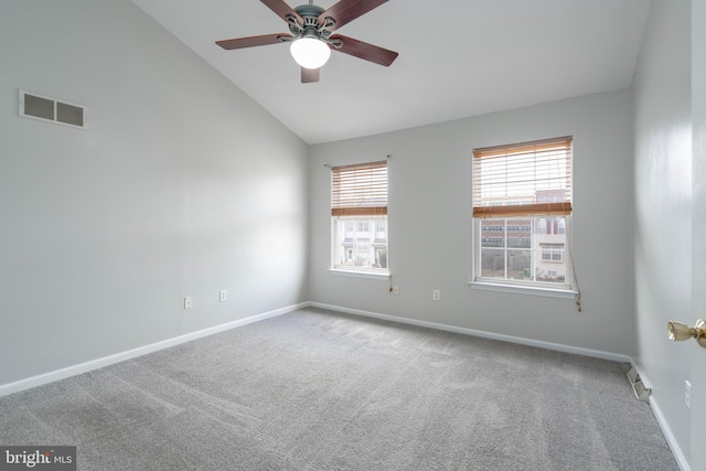 carpeted empty room featuring ceiling fan and high vaulted ceiling