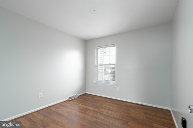 empty room featuring dark hardwood / wood-style flooring