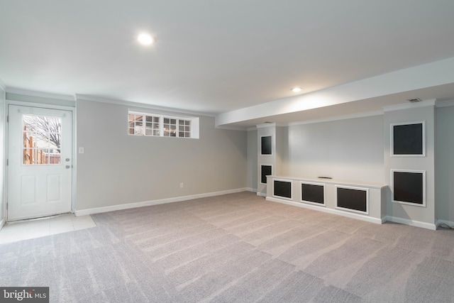 basement featuring light carpet and ornamental molding