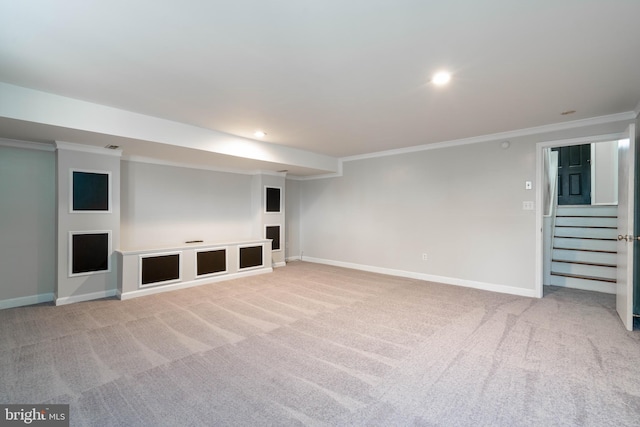 unfurnished living room with crown molding and light carpet