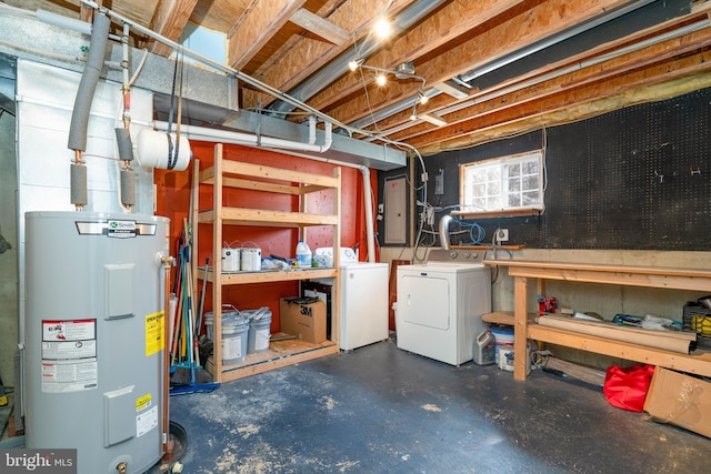 basement featuring washer and dryer, electric panel, and water heater