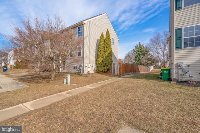 view of side of property with a lawn