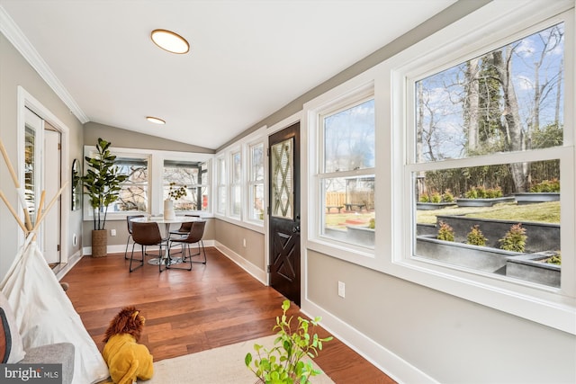 sunroom / solarium featuring lofted ceiling