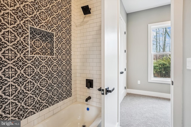 bathroom featuring tiled shower / bath and a healthy amount of sunlight