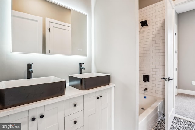 bathroom with vanity and tiled shower / bath combo