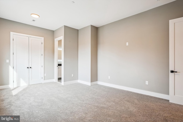 unfurnished bedroom featuring a closet and carpet flooring