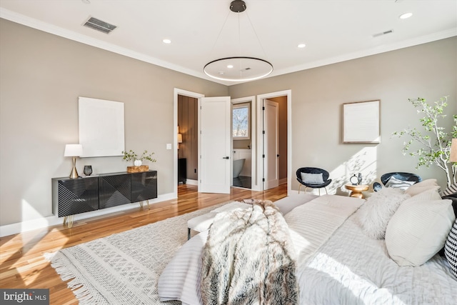 bedroom featuring ornamental molding and wood-type flooring