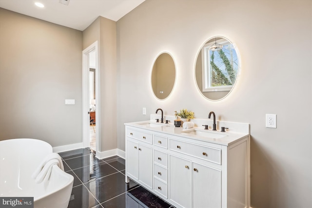 bathroom featuring tile patterned flooring, vanity, and a bathtub