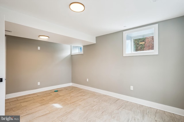 basement with light hardwood / wood-style floors