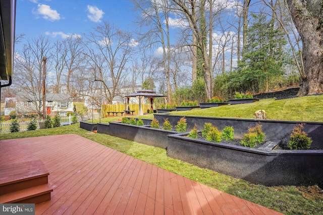 deck featuring a gazebo and a lawn