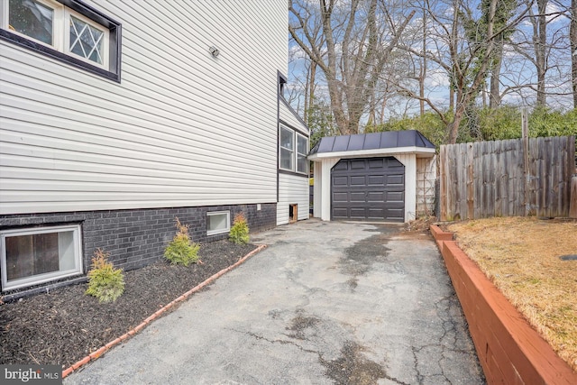 view of property exterior featuring a garage and an outbuilding