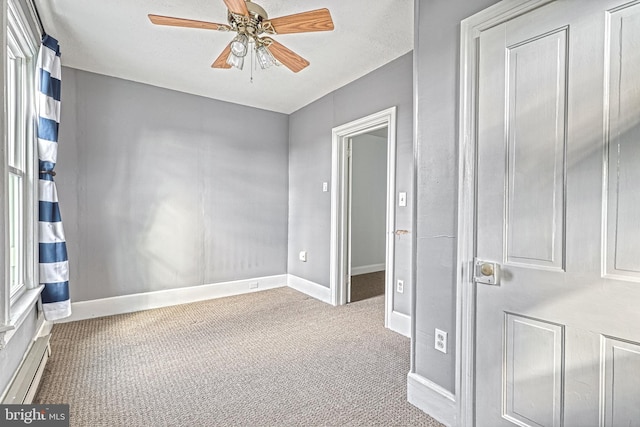 carpeted spare room featuring ceiling fan