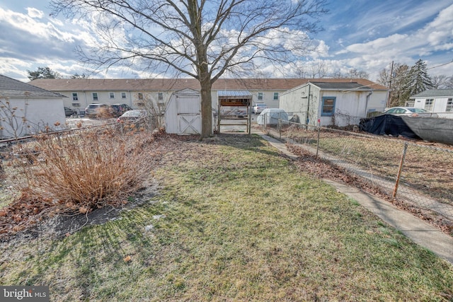 back of house with a storage shed and a yard