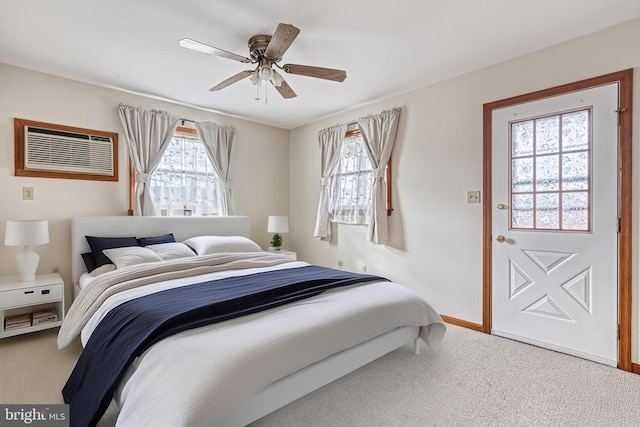 bedroom with multiple windows, a wall mounted air conditioner, ceiling fan, and carpet flooring