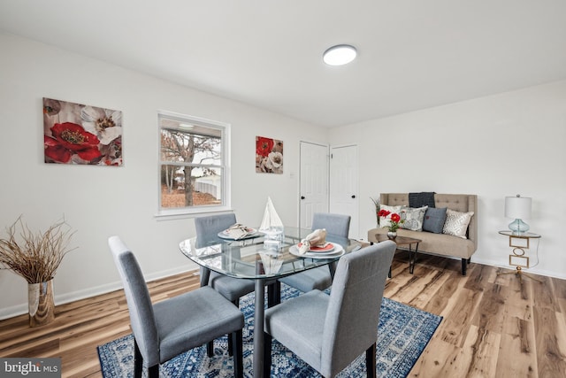dining area featuring wood finished floors and baseboards