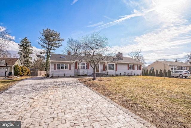 ranch-style home with a front lawn