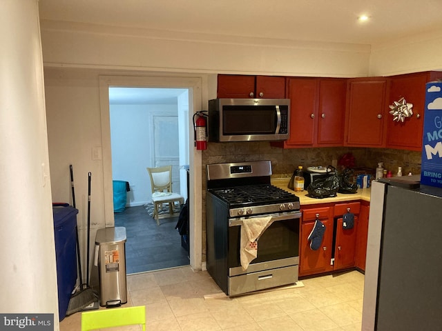 kitchen featuring stainless steel appliances and decorative backsplash