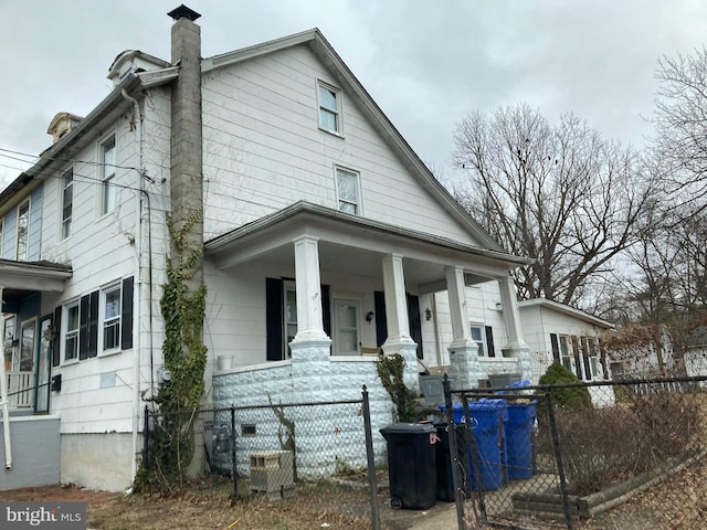 view of property exterior featuring central AC and covered porch