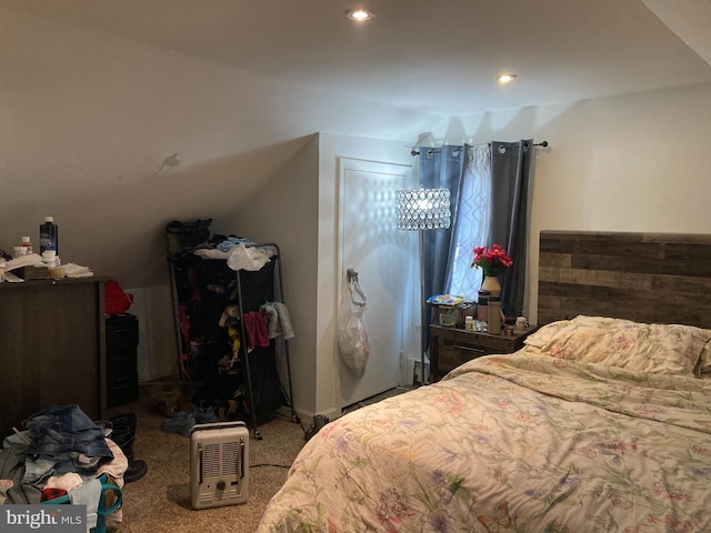 bedroom featuring lofted ceiling and carpet flooring