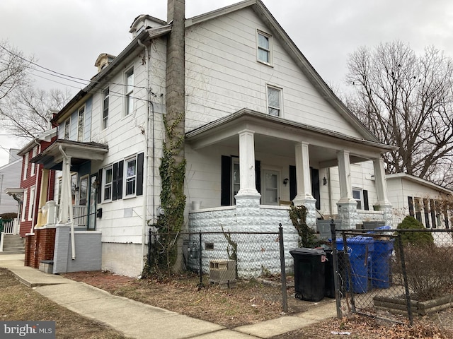 view of side of property with covered porch