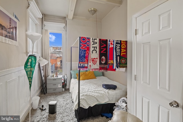 bedroom with beamed ceiling and carpet flooring