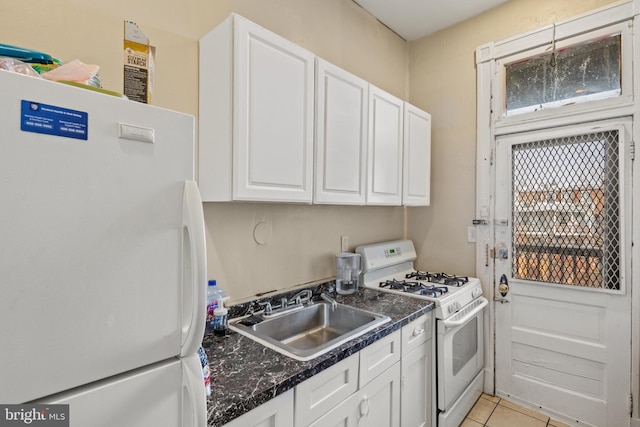 kitchen featuring white cabinetry, sink, light tile patterned floors, and white appliances