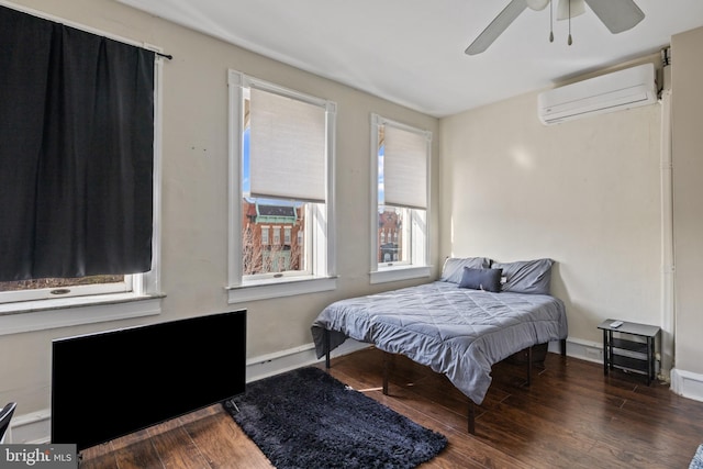 bedroom featuring dark hardwood / wood-style flooring, radiator, a wall mounted AC, and ceiling fan