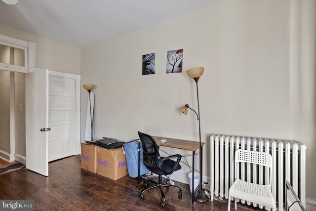 office space with radiator and dark wood-type flooring