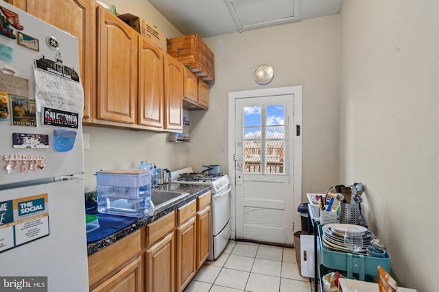 kitchen with light tile patterned flooring and white appliances