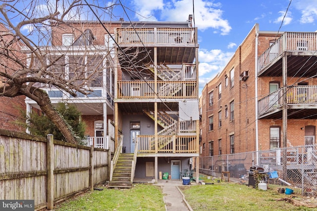 rear view of property with a lawn