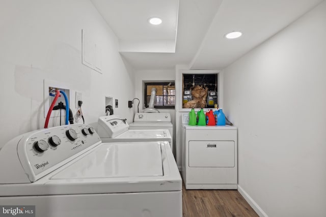 laundry room with washing machine and dryer and dark wood-type flooring