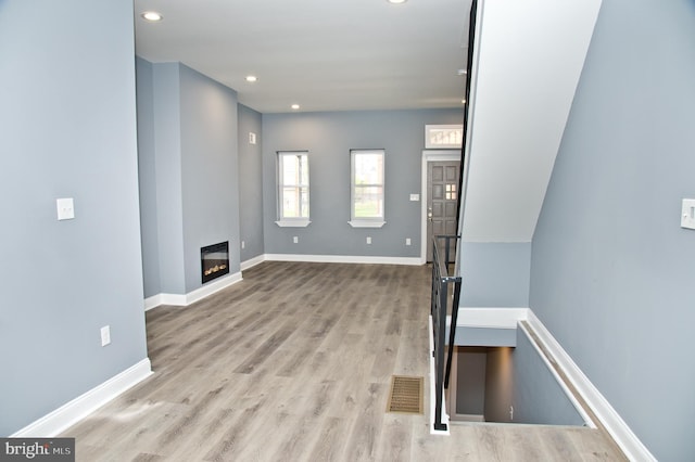 interior space featuring light wood-type flooring and a fireplace