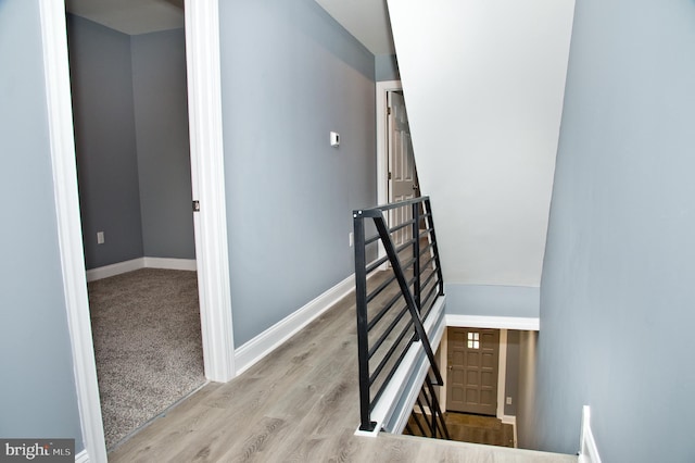 stairs with hardwood / wood-style floors