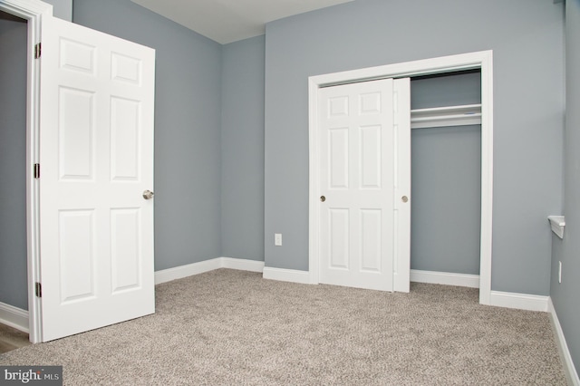 unfurnished bedroom with carpet floors and a closet