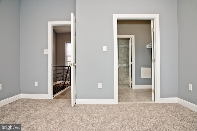 unfurnished bedroom with light colored carpet