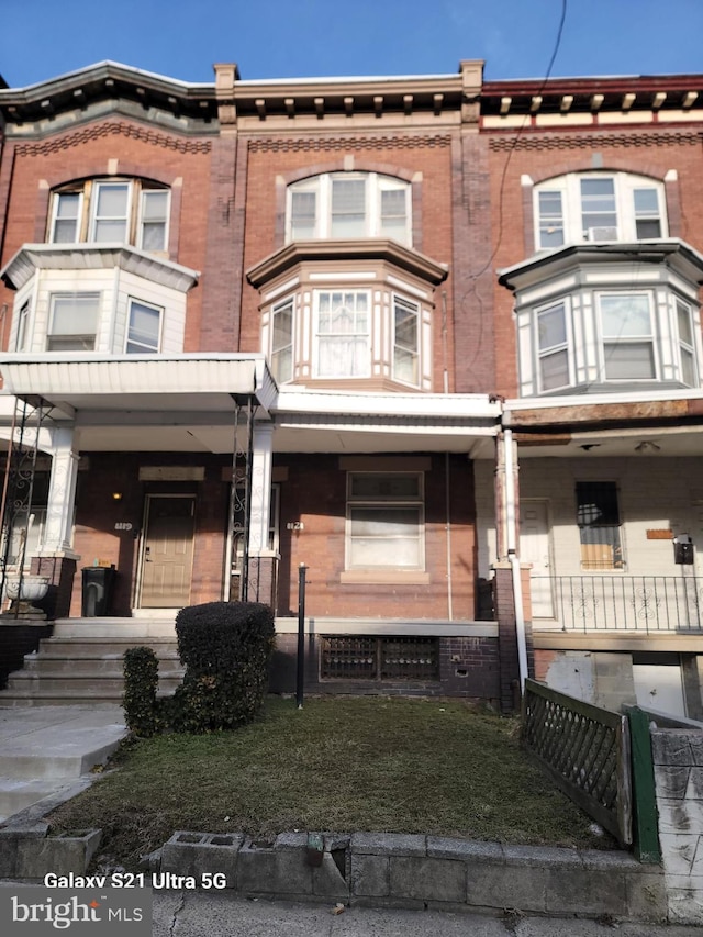 townhome / multi-family property with covered porch