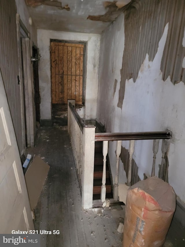 stairway with hardwood / wood-style flooring