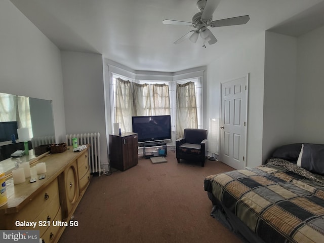 carpeted bedroom with radiator heating unit and ceiling fan