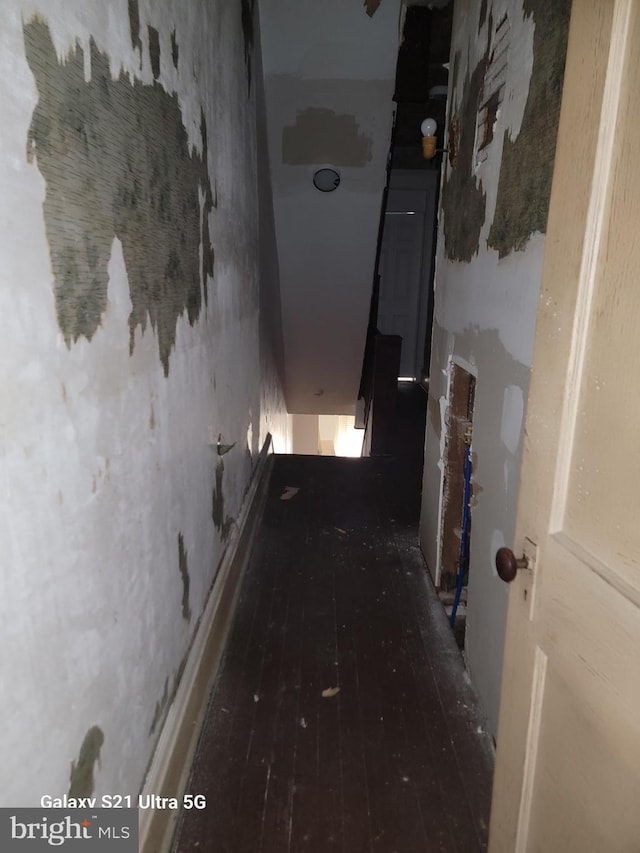 hallway with hardwood / wood-style flooring