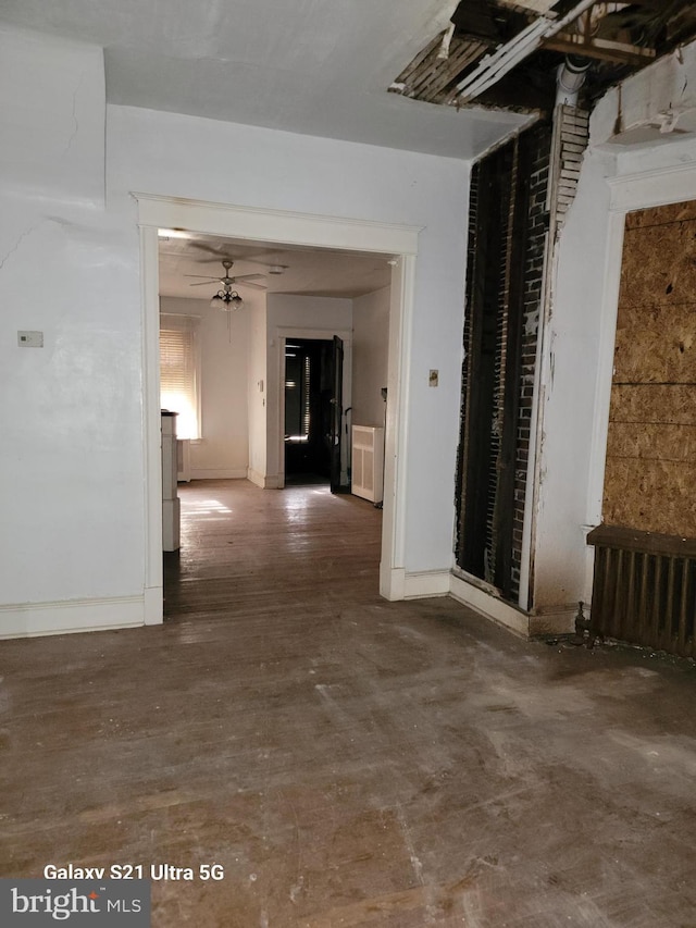 empty room with radiator heating unit and ceiling fan