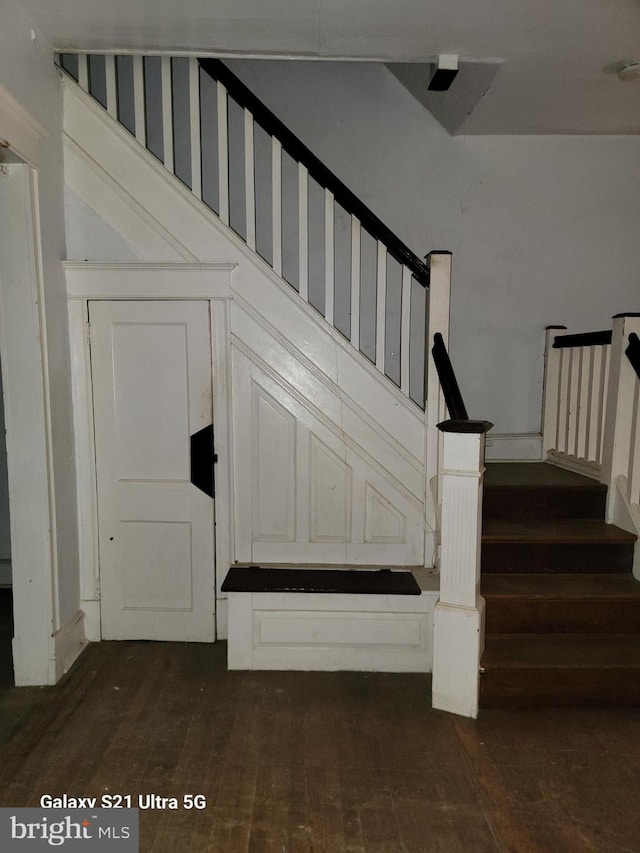 staircase with wood-type flooring