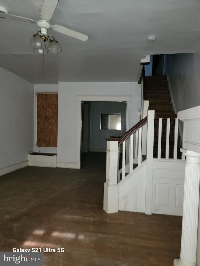 stairs featuring ceiling fan